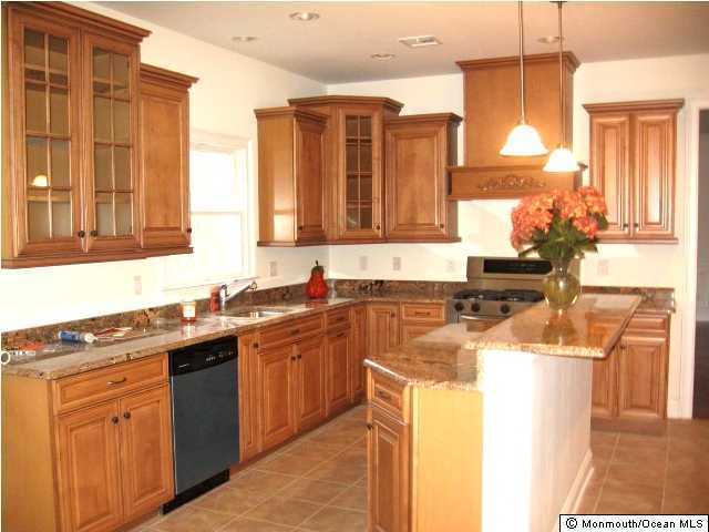 147 Millhurst Road Manalapan, NJ 07726 - Photo 3 of 3 a kitchen with stainless steel appliances granite countertop a sink stove and cabinets
