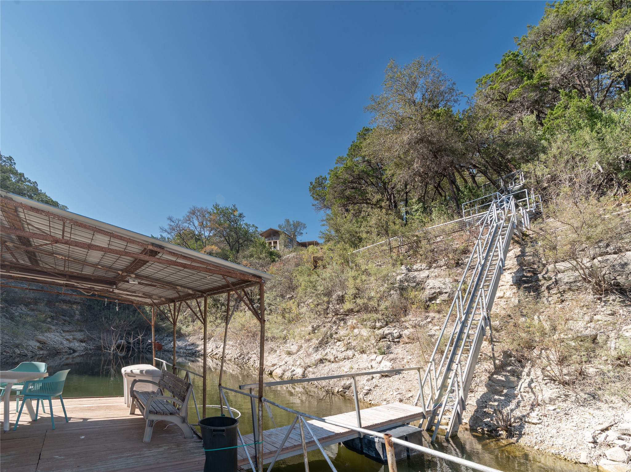 3807 Boat Dock Road Lago Vista, TX 78645 - Photo 28 of 37 Lakeside oasis with a private boat dock and covered deck, perfect for waterfront enjoyment.