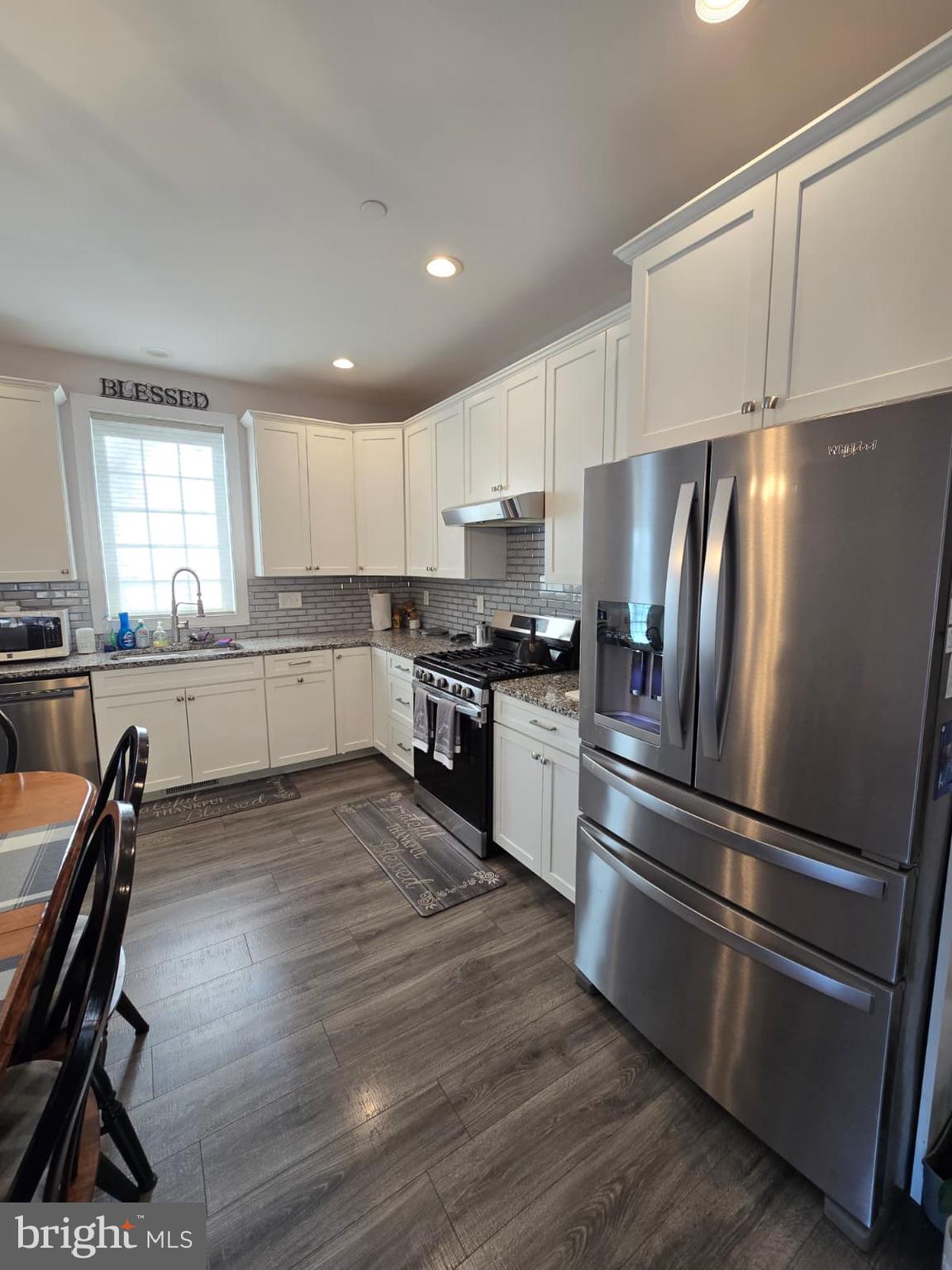 209 3rd Street Crumpton, MD 21628 - Photo 18 of 53 a kitchen with granite countertop stainless steel appliances and wooden cabinets