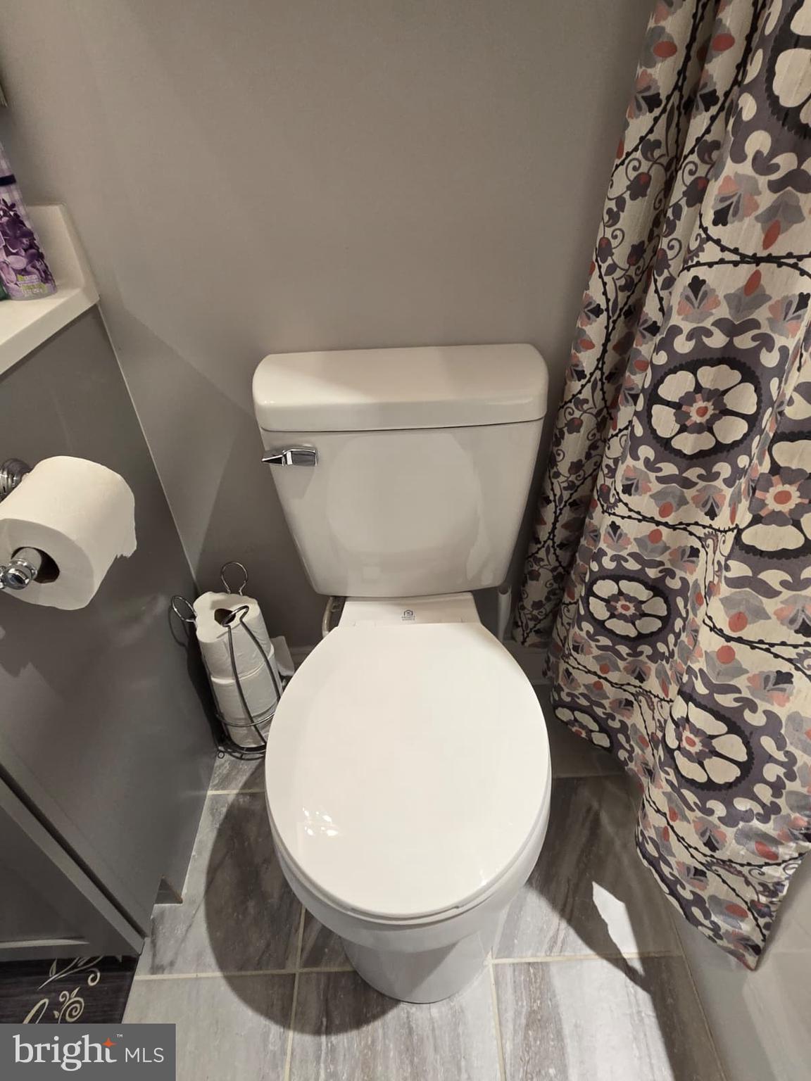 209 3rd Street Crumpton, MD 21628 - Photo 34 of 53 a white toilet sitting next to a shower curtain