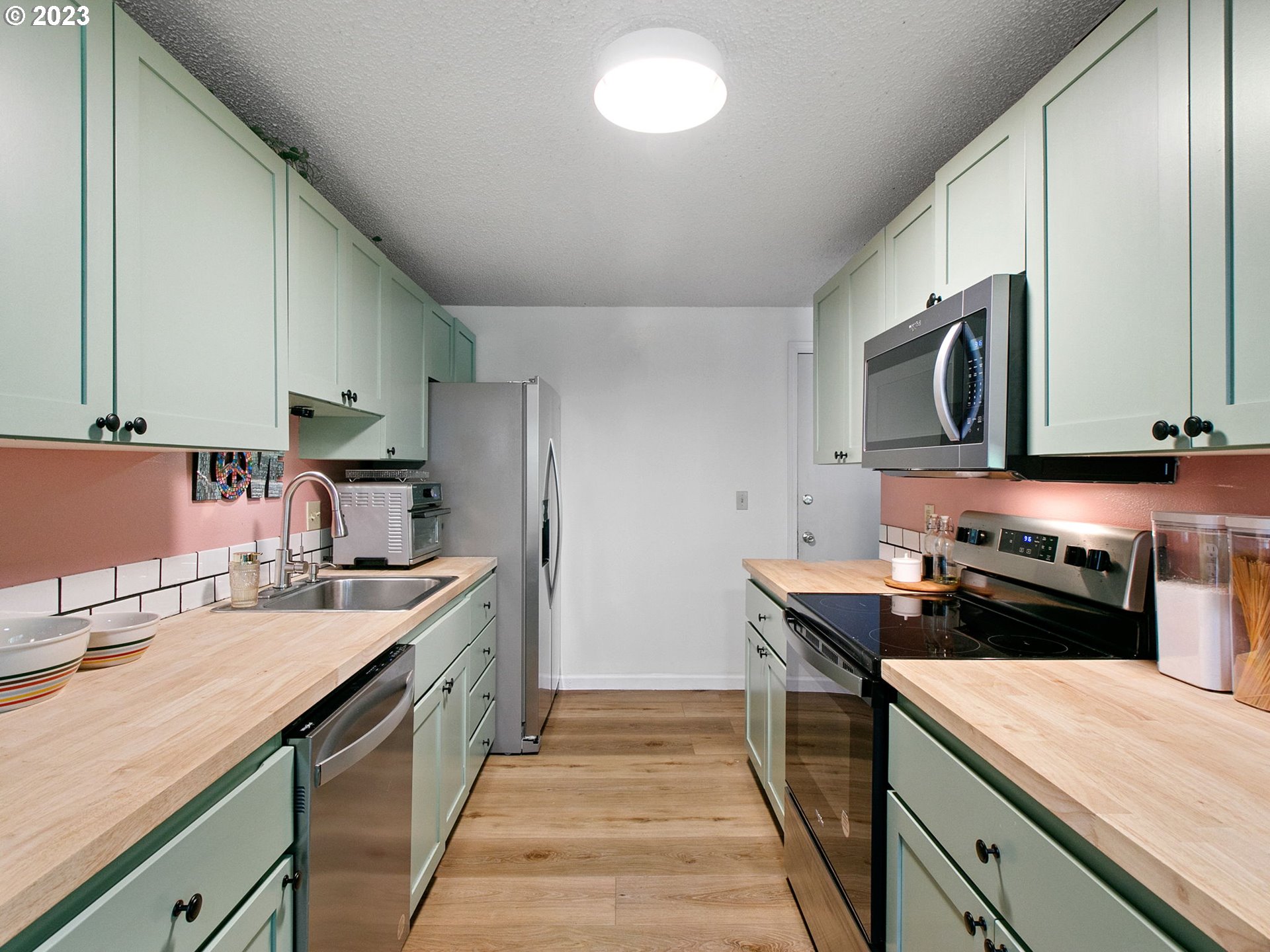 2369 Southeast 112th Avenue, Unit 7 Portland, OR 97216 - Photo 12 of 32 a kitchen with a sink stove top oven and refrigerator