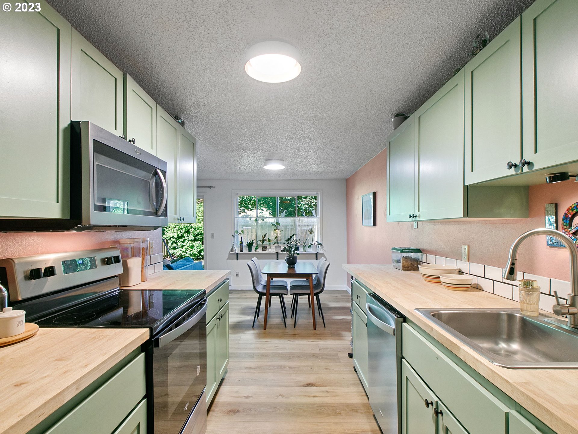 2369 Southeast 112th Avenue, Unit 7 Portland, OR 97216 - Photo 14 of 32 a kitchen with a sink stove and microwave