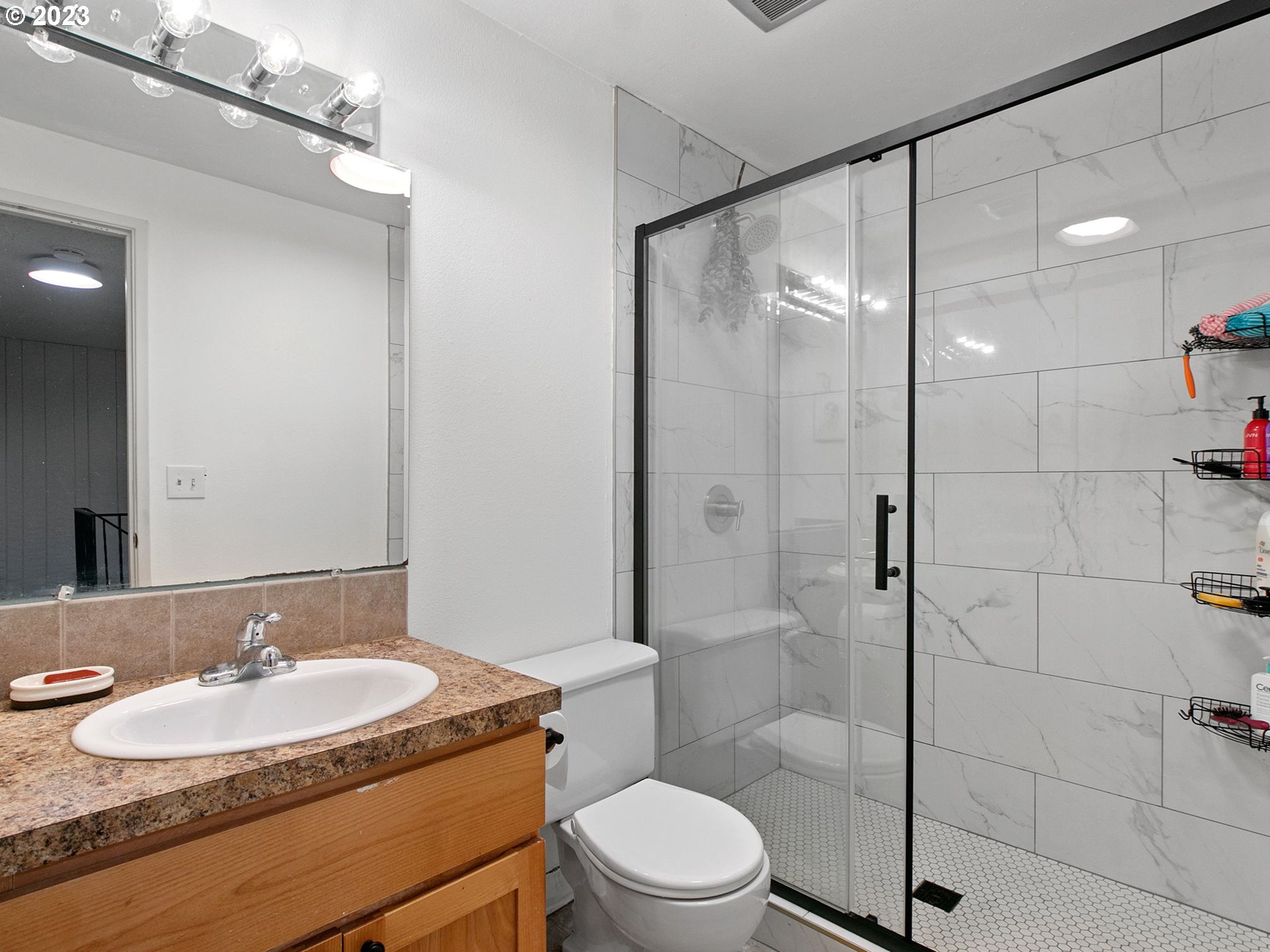 2369 Southeast 112th Avenue, Unit 7 Portland, OR 97216 - Photo 21 of 32 a bathroom with a sink a toilet and shower