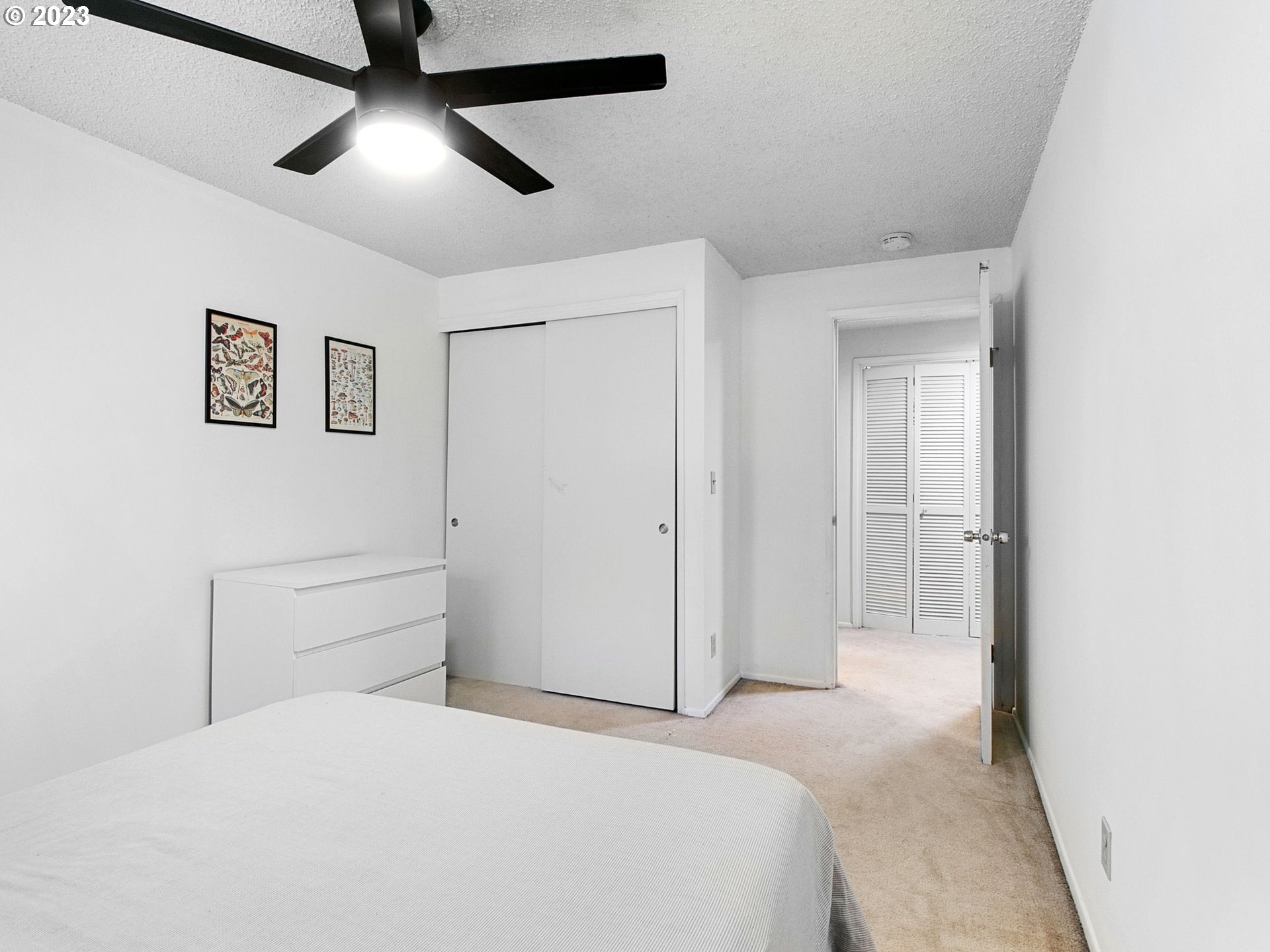 2369 Southeast 112th Avenue, Unit 7 Portland, OR 97216 - Photo 26 of 32 a bedroom with a bed and a chandelier