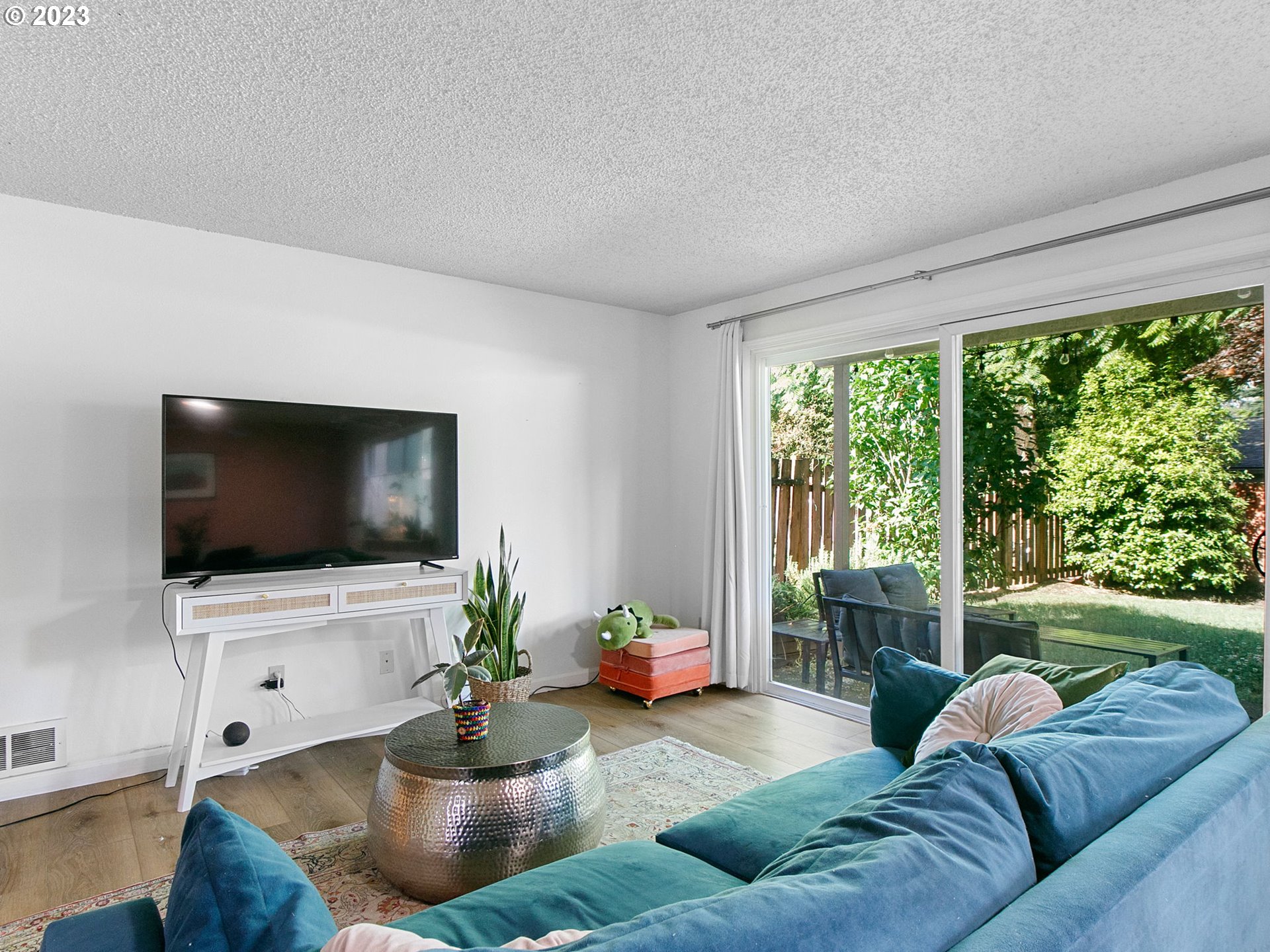 2369 Southeast 112th Avenue, Unit 7 Portland, OR 97216 - Photo 6 of 32 a living room with furniture and a flat screen tv