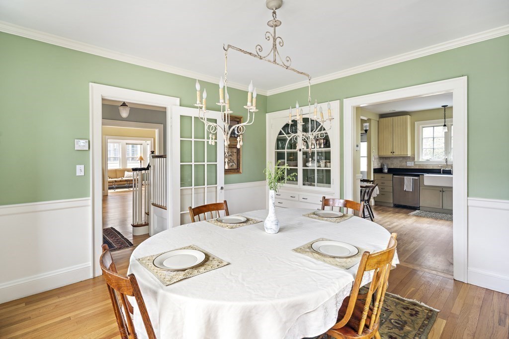 39 Somerset Road Brookline, MA 02445 - Photo 17 of 41 a dining room with wooden floor a chandelier a wooden table and chairs