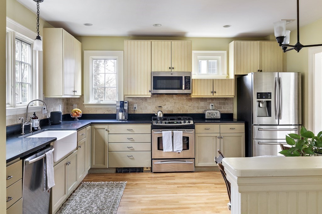 39 Somerset Road Brookline, MA 02445 - Photo 21 of 41 a kitchen with stainless steel appliances white cabinets a sink a stove a refrigerator and a microwave