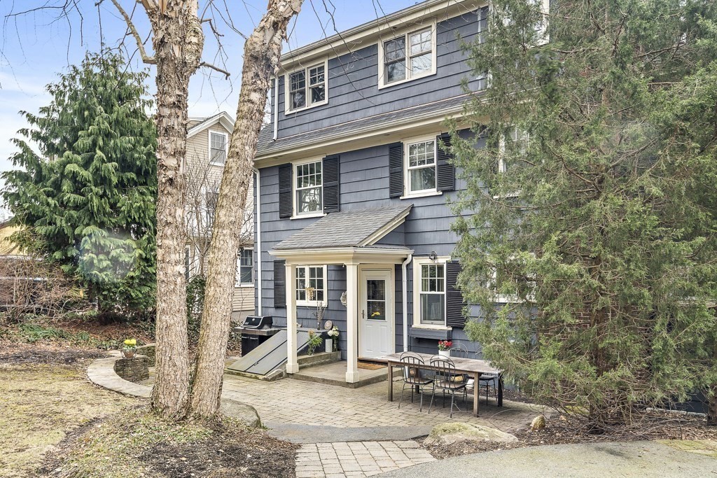39 Somerset Road Brookline, MA 02445 - Photo 3 of 41 a view of a brick house with chairs and table in a patio