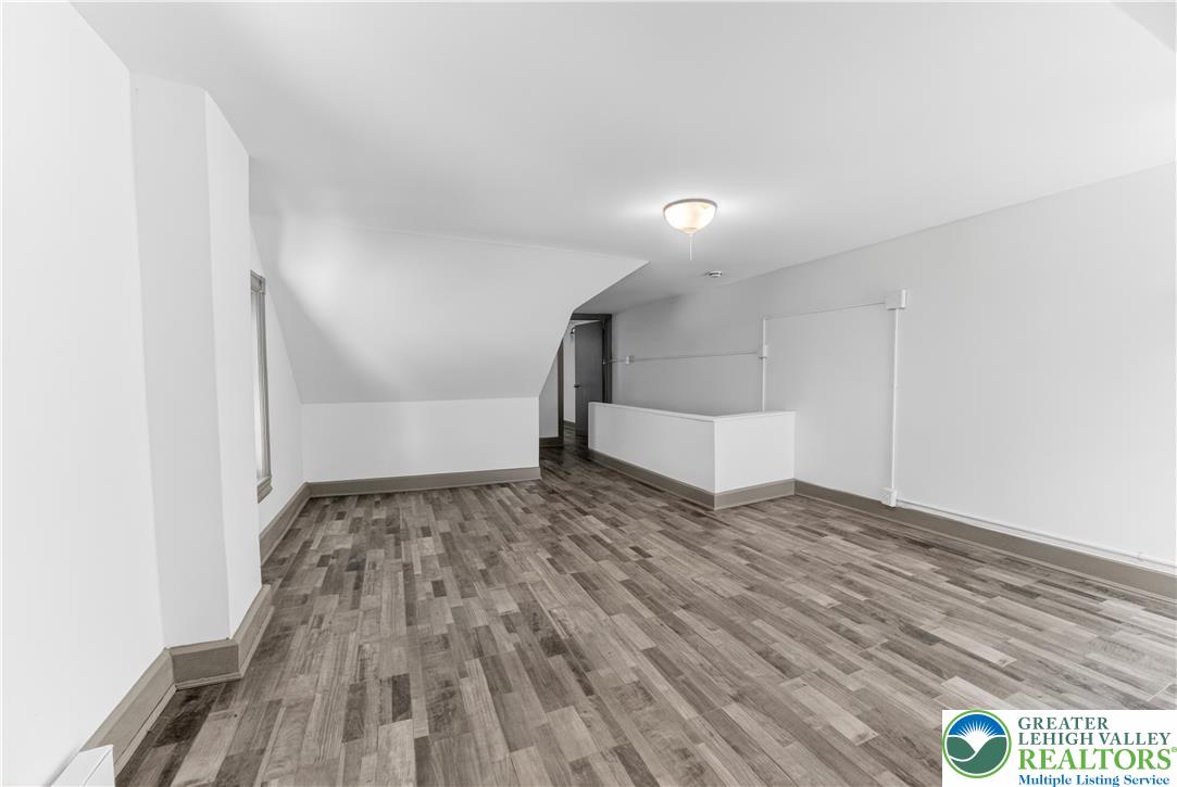 1128 Maple Street Bethlehem, PA 18018 - Photo 9 of 34 A versatile open space with sloped ceilings and durable flooring awaits your personal touch.