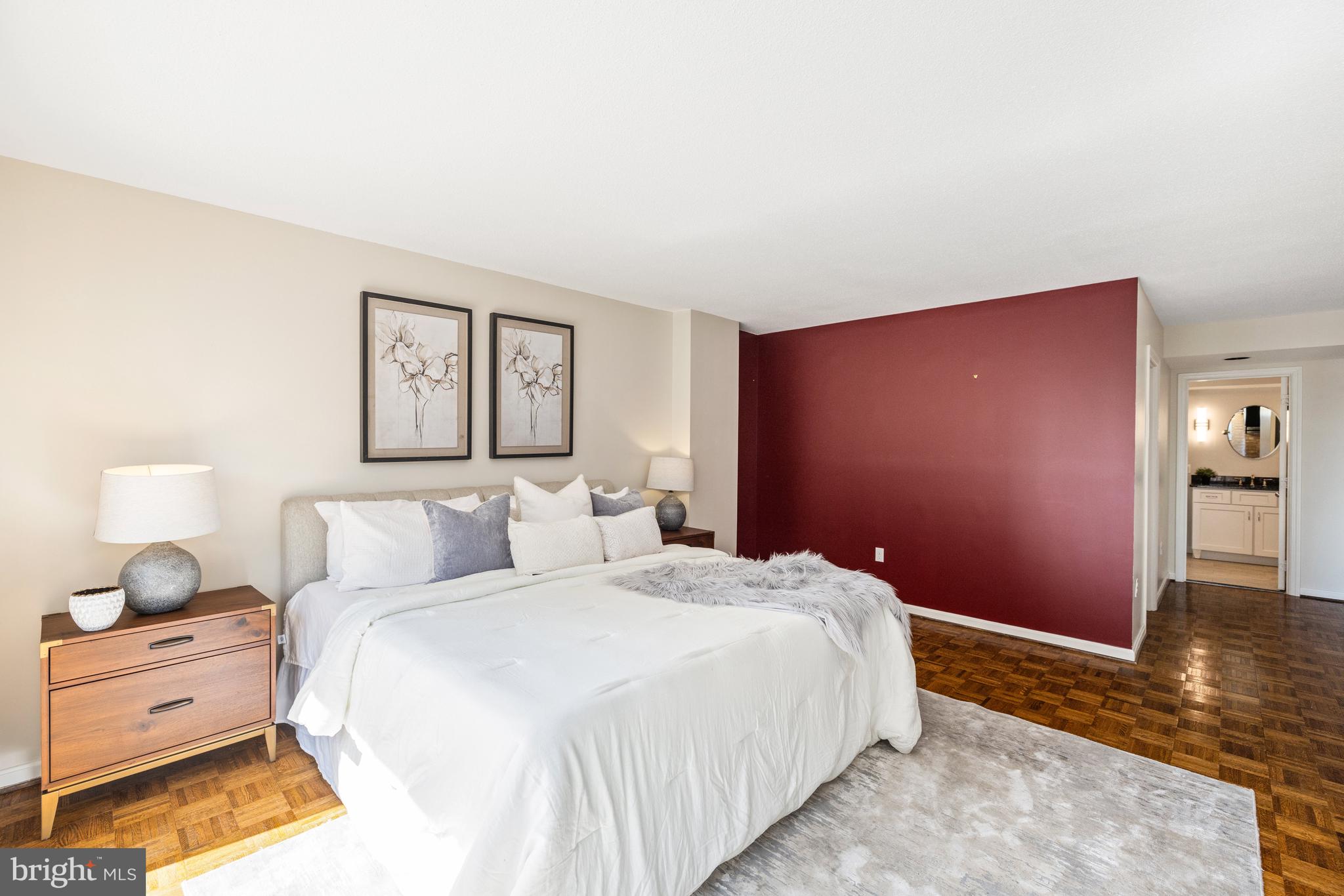 1015 33rd Street Northwest, Unit 507 Washington, DC 20007 - Photo 13 of 20 a spacious bedroom with a bed and a lamp