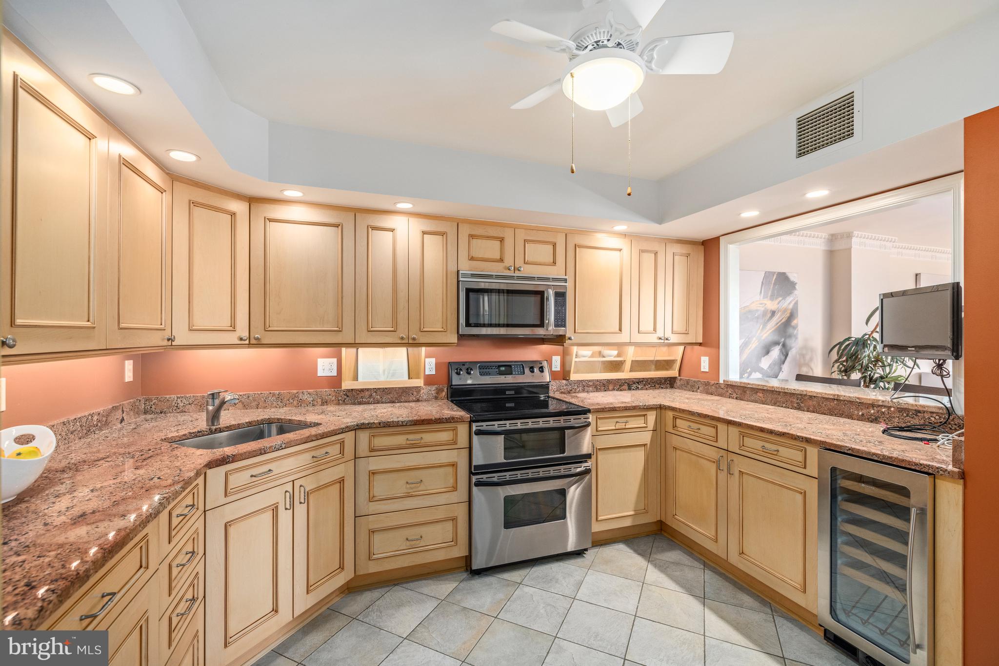 1015 33rd Street Northwest, Unit 507 Washington, DC 20007 - Photo 8 of 20 a kitchen with stainless steel appliances granite countertop a stove sink and microwave