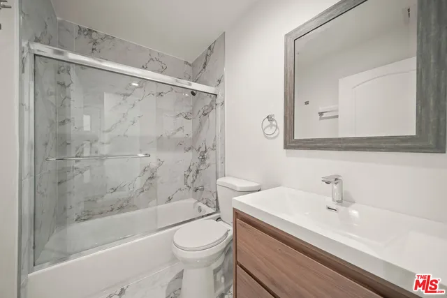 a bathroom with a sink a toilet and a bathtub