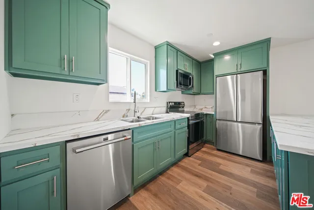 a kitchen with a sink cabinets and stainless steel appliances