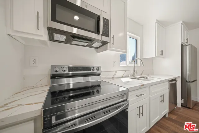 a kitchen with appliances and cabinets