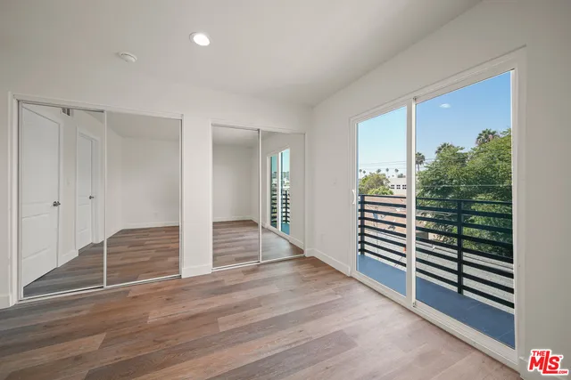 a view of a livingroom with wooden floor and stairs
