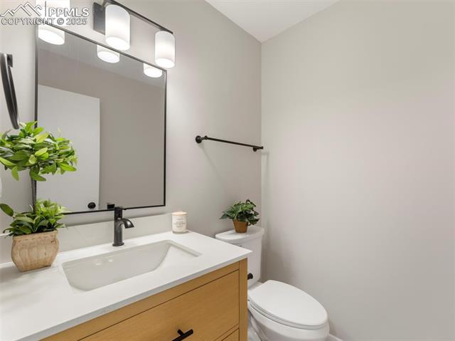 4741 Barnes Road Colorado Springs, CO 80917 - Photo 14 of 36 Half bathroom featuring new vanity and toilet