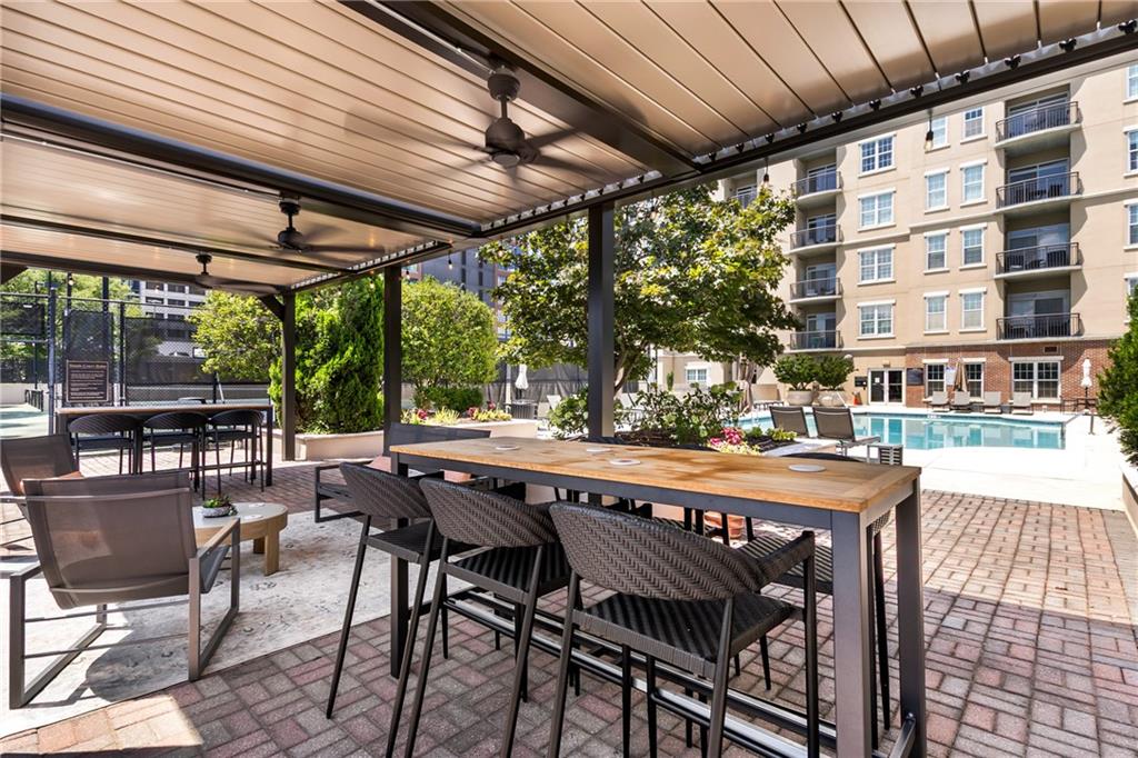 325 East Paces Ferry Road Northeast, Unit 1704 Atlanta, GA 30305 - Photo 21 of 29 a patio with glass top table and chairs