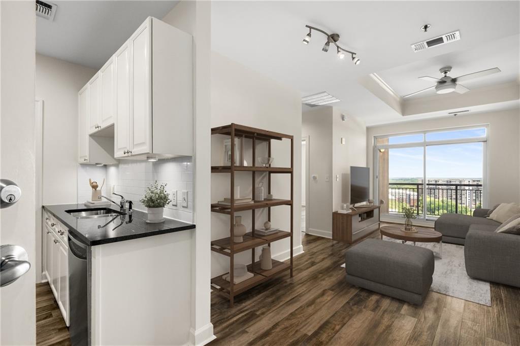 325 East Paces Ferry Road Northeast, Unit 1704 Atlanta, GA 30305 - Photo 5 of 29 a kitchen that has a sink and a stove with wooden floor