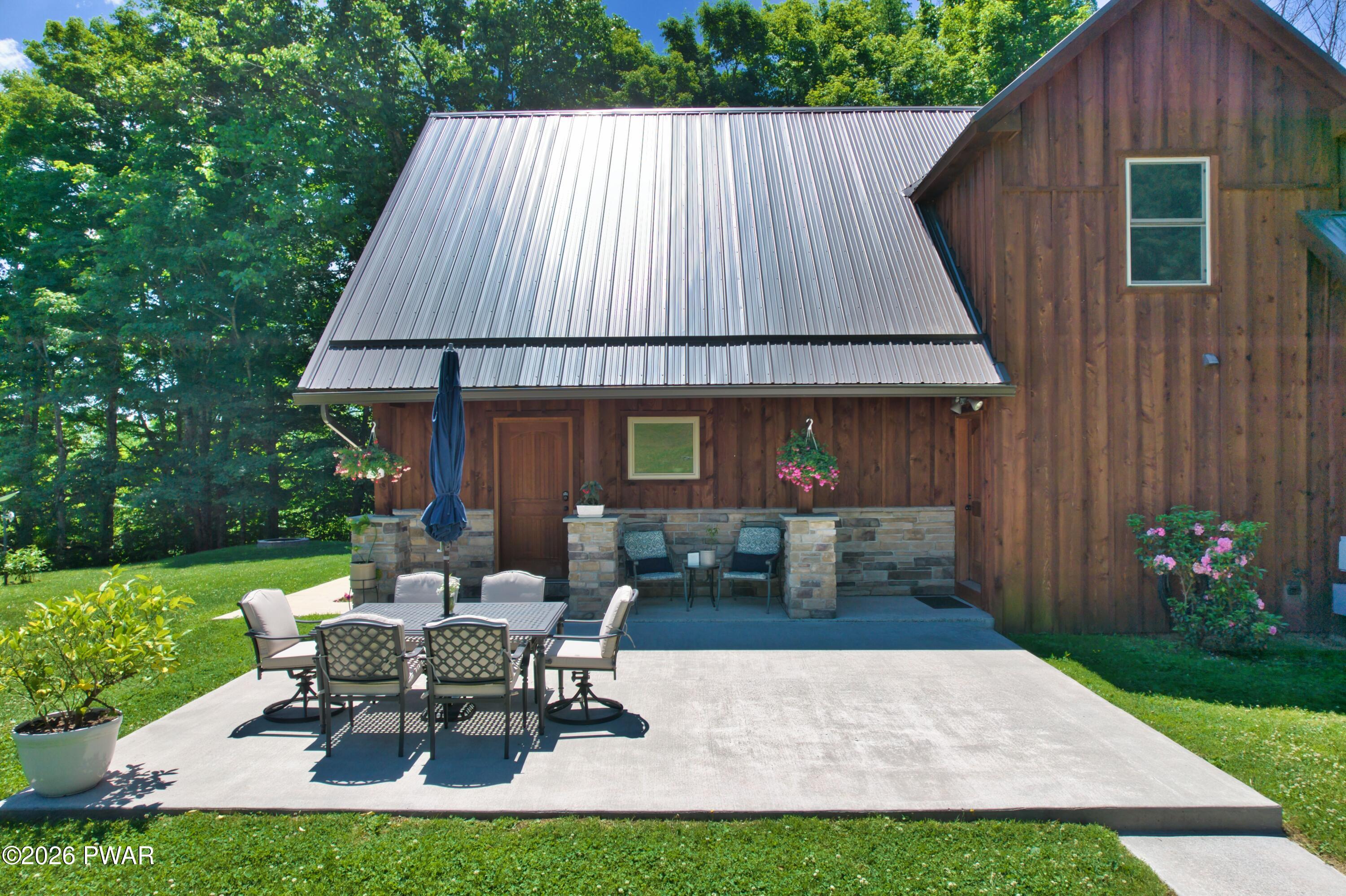 149 Sheards Road Milanville, PA 18443 - Photo 4 of 57 a backyard of a house with table and chairs