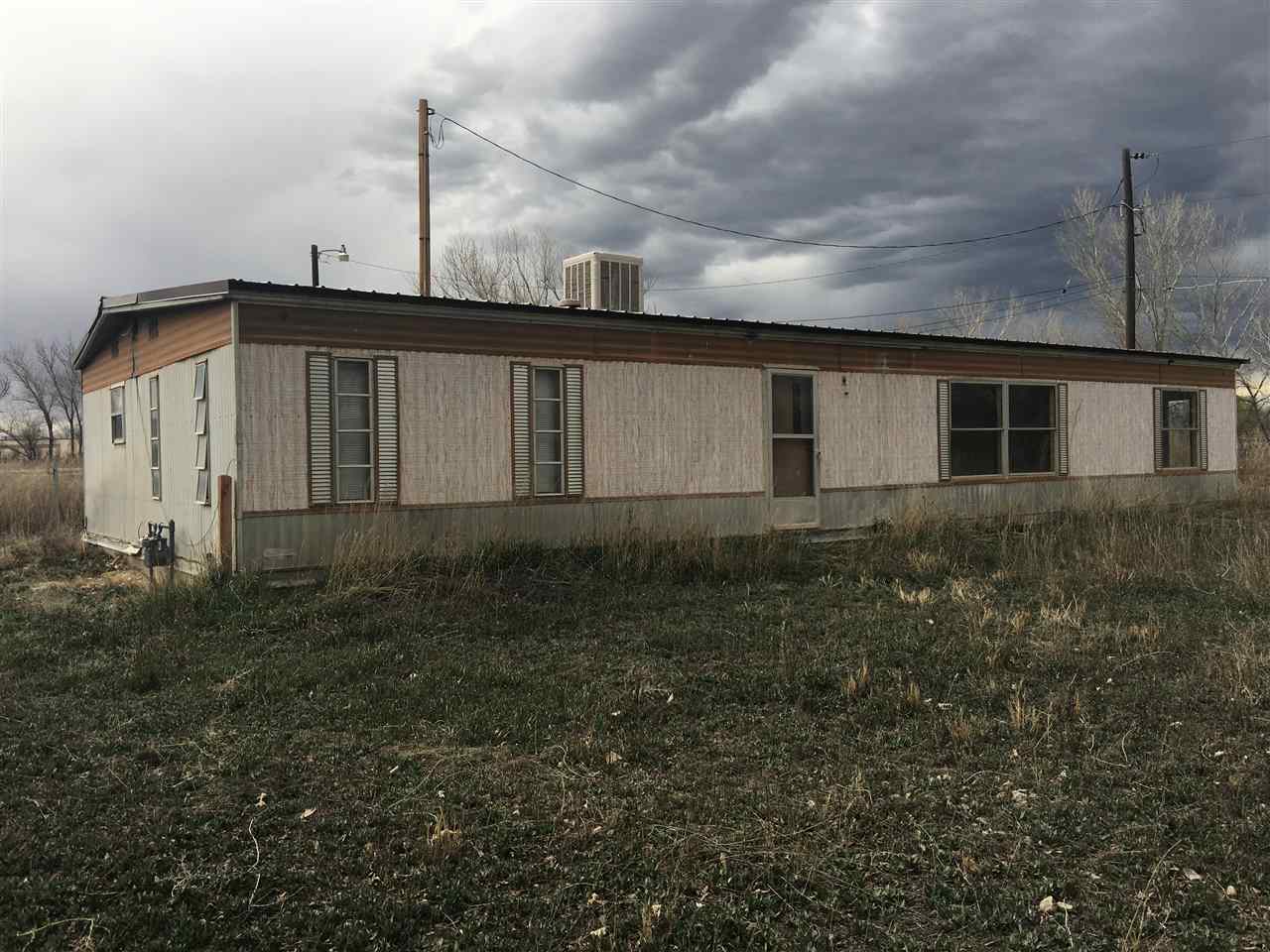 843 21 Road Fruita, CO 81521 - Photo 2 of 5 a front view of a house with garden
