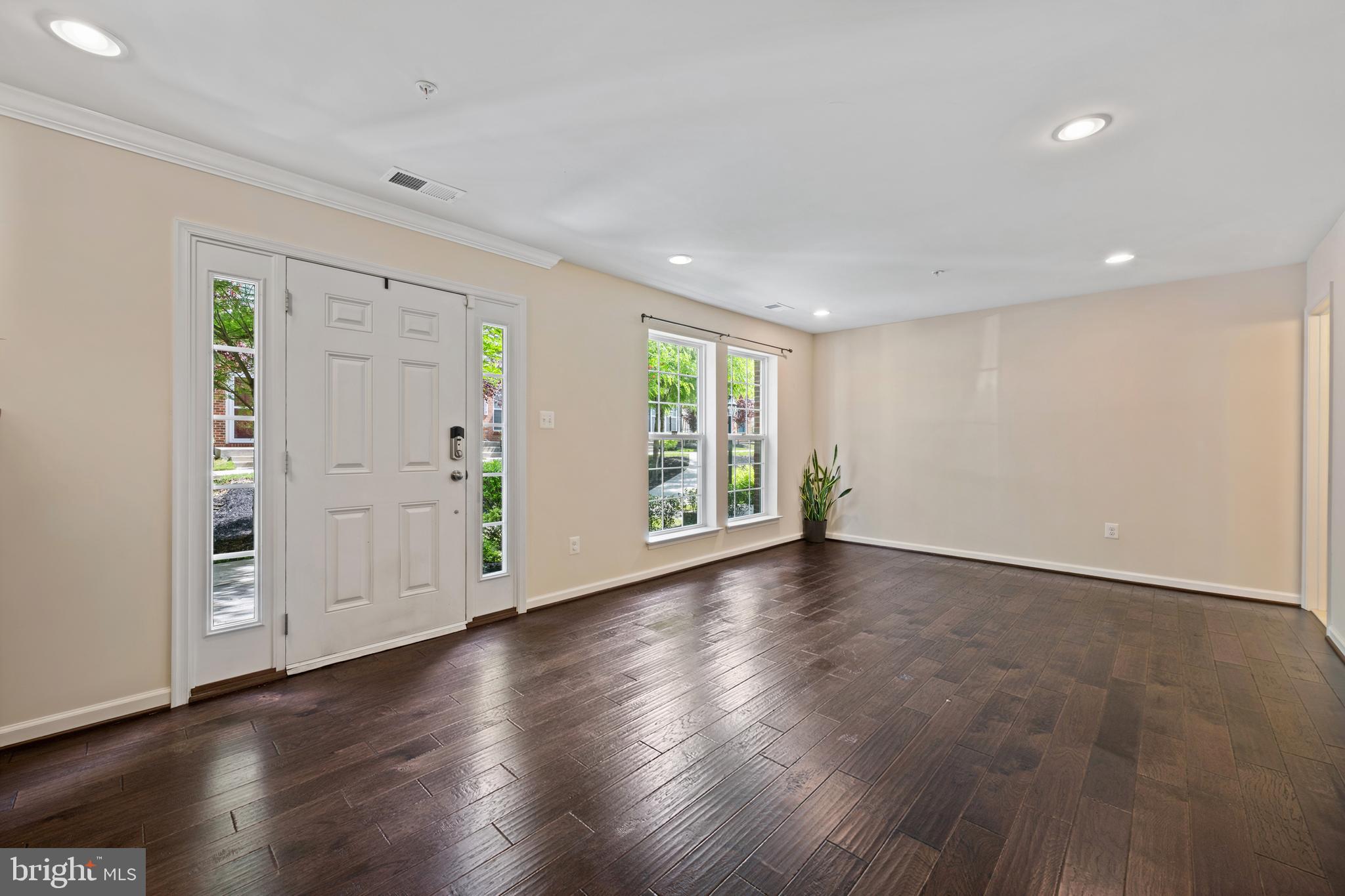 7062 Foxton Way Hanover, MD 21076 - Photo 5 of 41 an empty room with wooden floor and windows