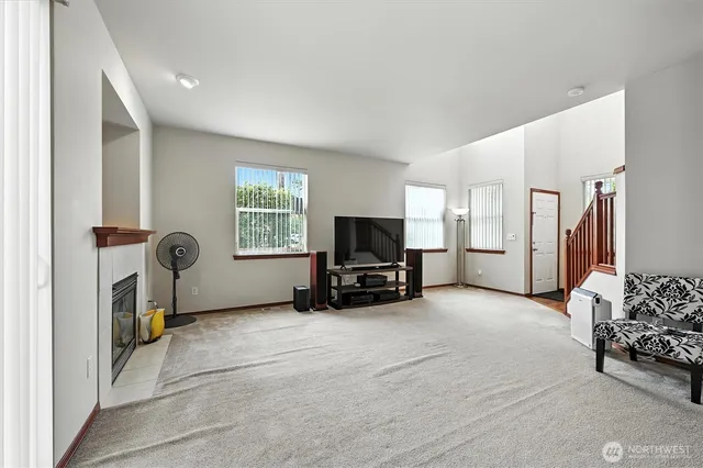 a open kitchen with stainless steel appliances granite countertop a refrigerator a sink a stove a microwave and island with wooden cabinets