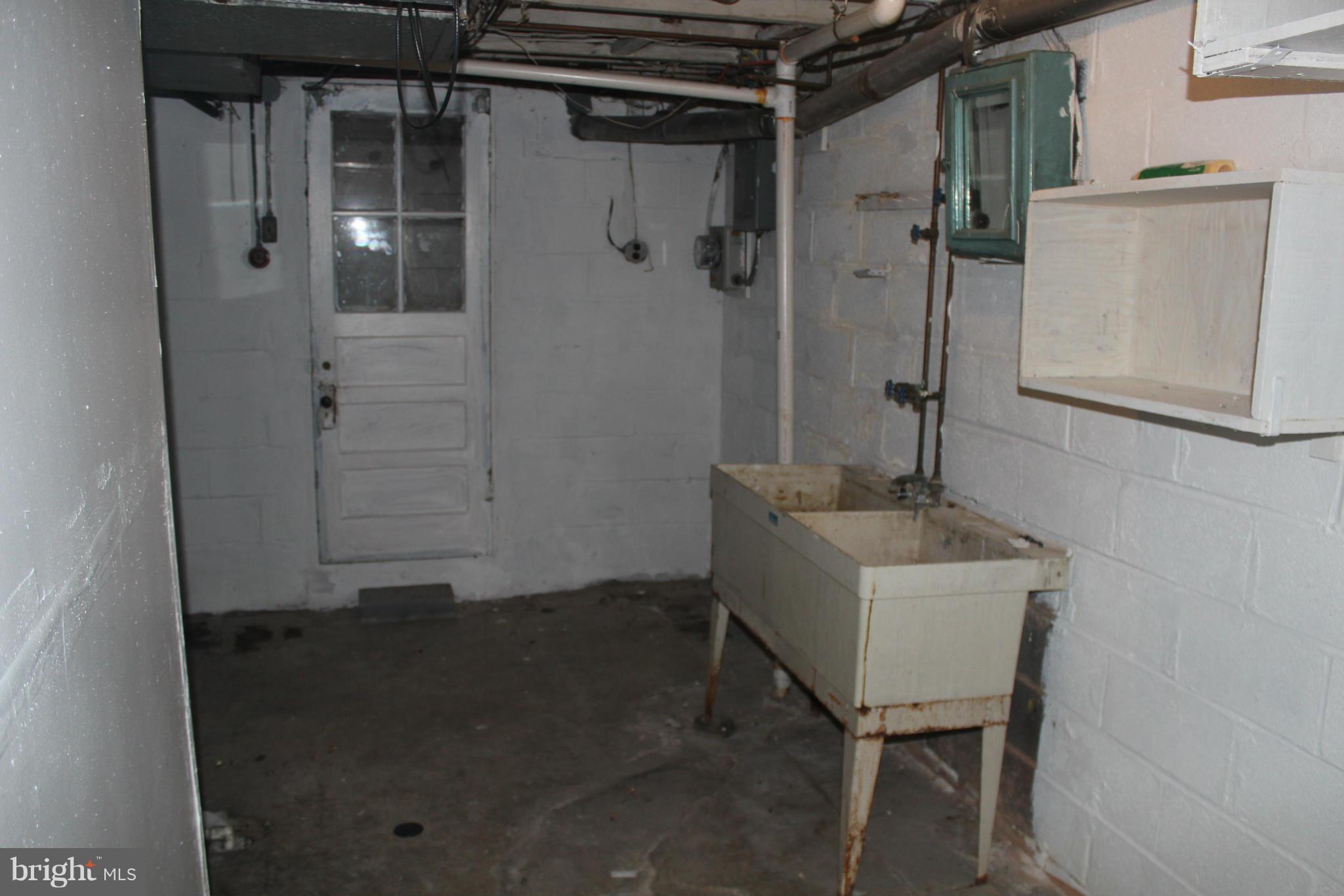 629 Roundview Road Baltimore, MD 21225 - Photo 12 of 26 a bathroom with a sink toilet and shower
