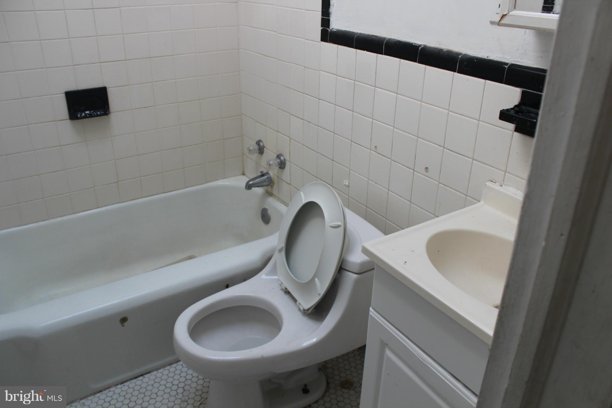 629 Roundview Road Baltimore, MD 21225 - Photo 21 of 26 a bathroom with a toilet and a sink
