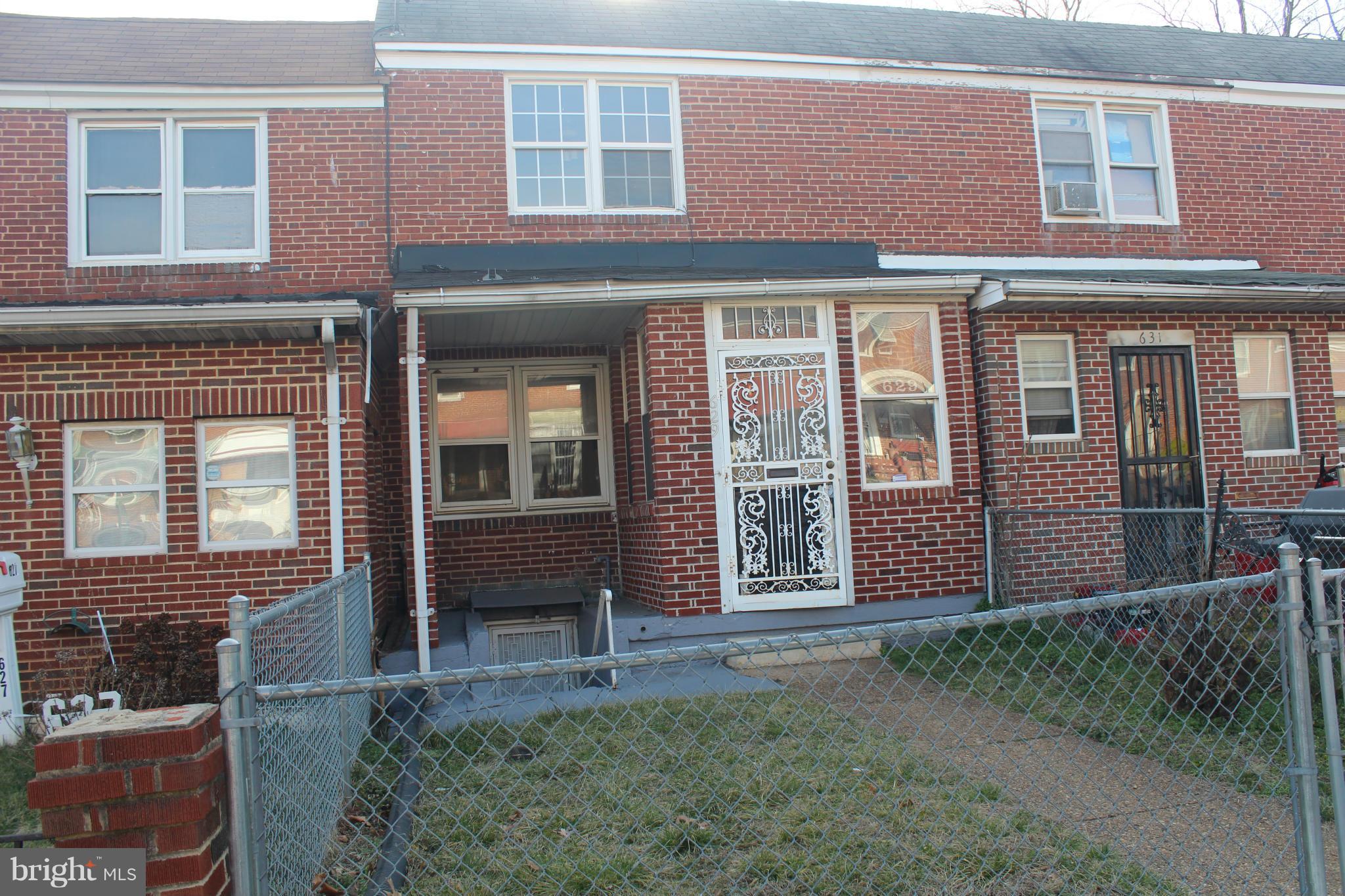 629 Roundview Road Baltimore, MD 21225 - Photo 24 of 26 a front view of a house having yard