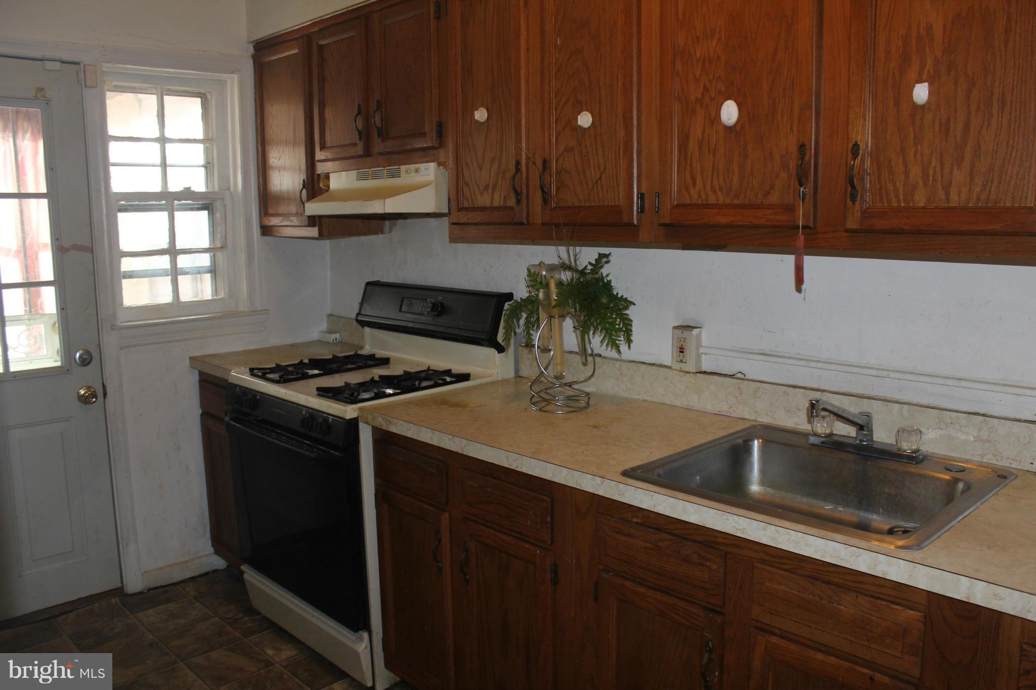 629 Roundview Road Baltimore, MD 21225 - Photo 6 of 26 a kitchen with stainless steel appliances granite countertop a sink stove and cabinets