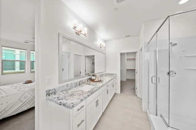 a bathroom with a sink double vanity and a mirror