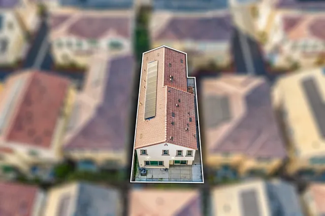 an aerial view of a house with a yard