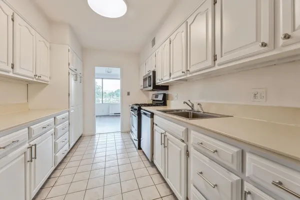 a kitchen with cabinets appliances and a sink