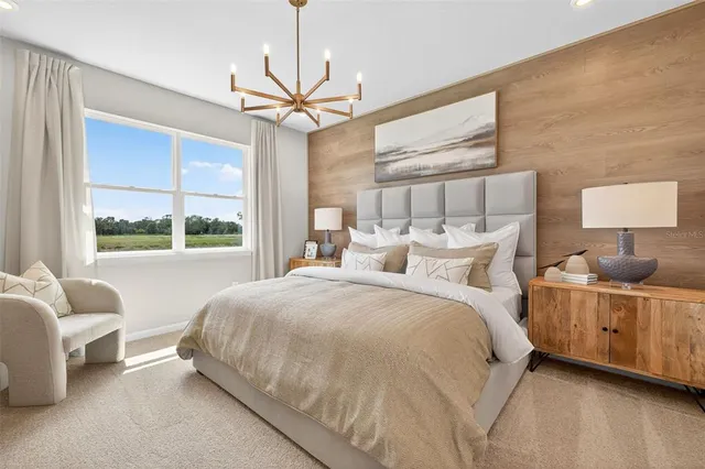 a large bed sitting in a bedroom next to a window