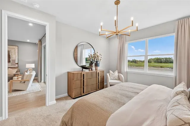 a bedroom with bed and a chandelier