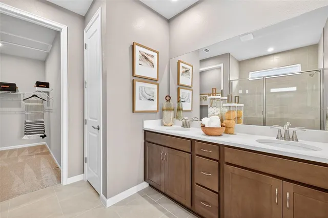 a bathroom with double sink and a mirror