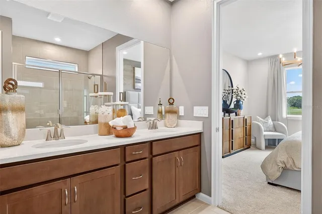 a en suite bathroom with double sink and a mirror