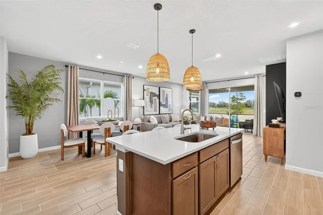 a very nice looking dining room with a large center island and a wooden floor