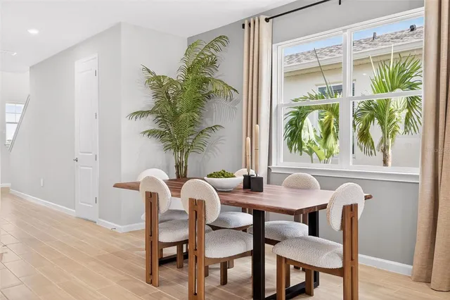 a view of a dining room with furniture window and outside view