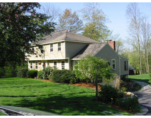 49 Barton Road Stow, MA 01775 - Photo 1 of 10 a front view of house with yard and green space