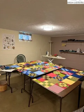 a living room with furniture and a gym