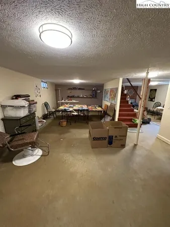 a view of a house with a yard covered in snow