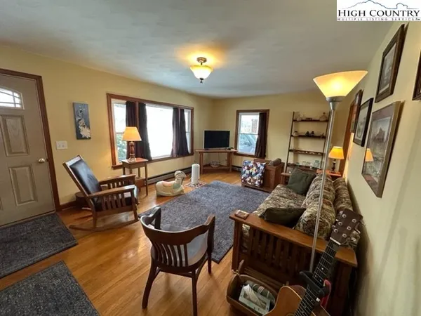a living room with furniture and wooden floor