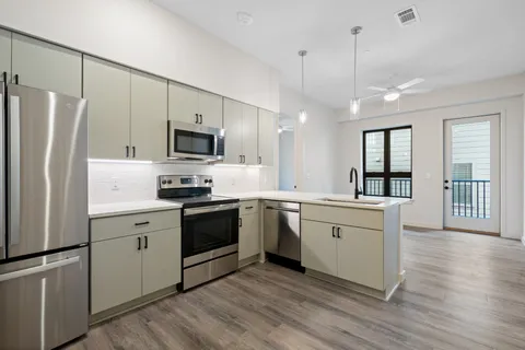 a kitchen with a refrigerator stove and sink