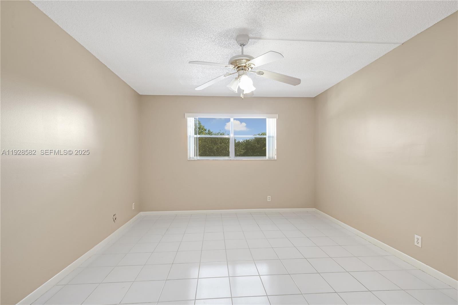 8305 Northwest 61st Street, Unit C305 Tamarac, FL 33321 - Photo 11 of 24 an empty room with a window