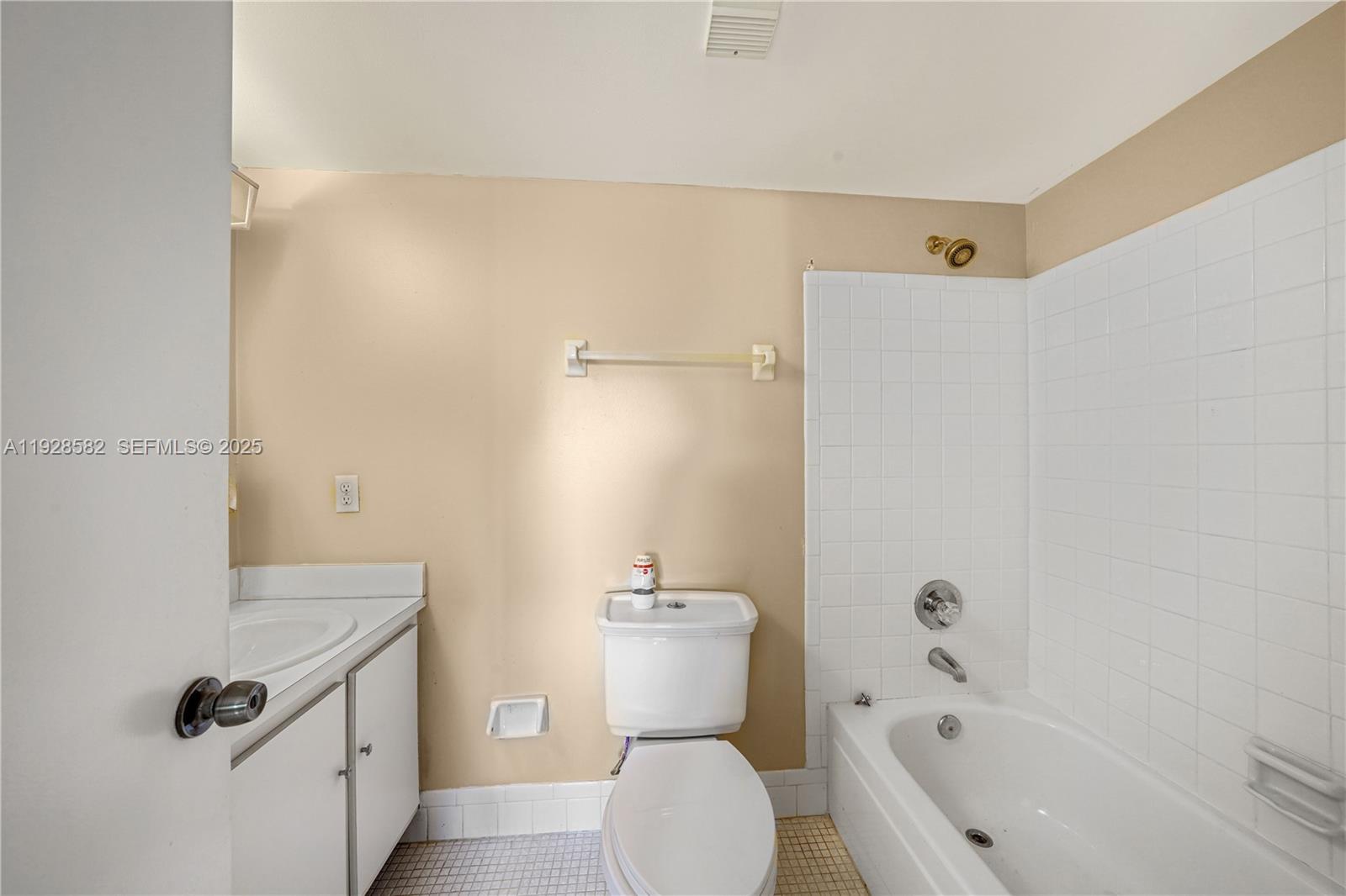 8305 Northwest 61st Street, Unit C305 Tamarac, FL 33321 - Photo 13 of 24 a bathroom with a sink a toilet and shower