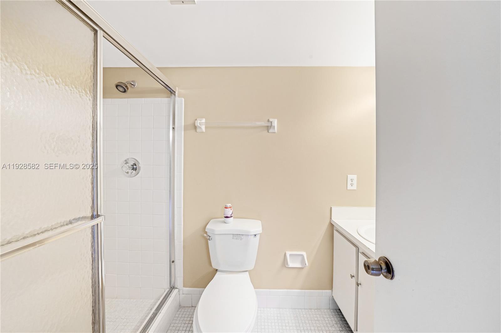 8305 Northwest 61st Street, Unit C305 Tamarac, FL 33321 - Photo 16 of 24 a bathroom with a toilet and a shower