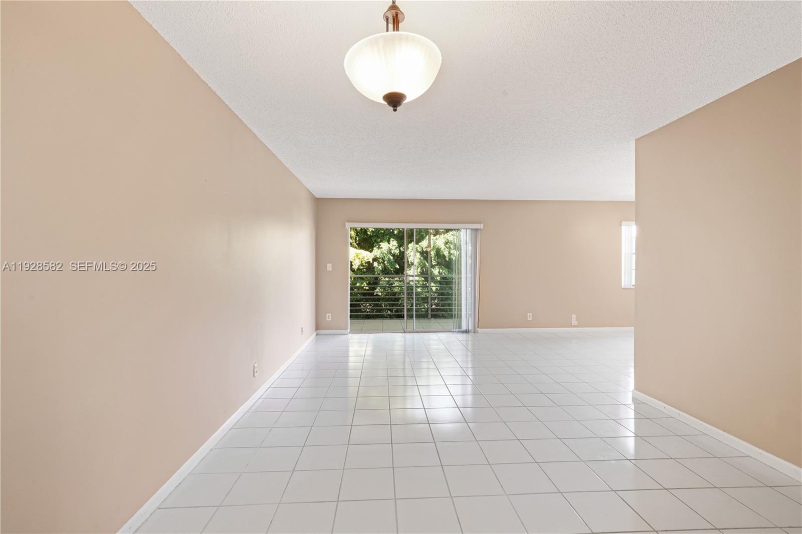 8305 Northwest 61st Street, Unit C305 Tamarac, FL 33321 - Photo 5 of 24 a view of an empty room with a window