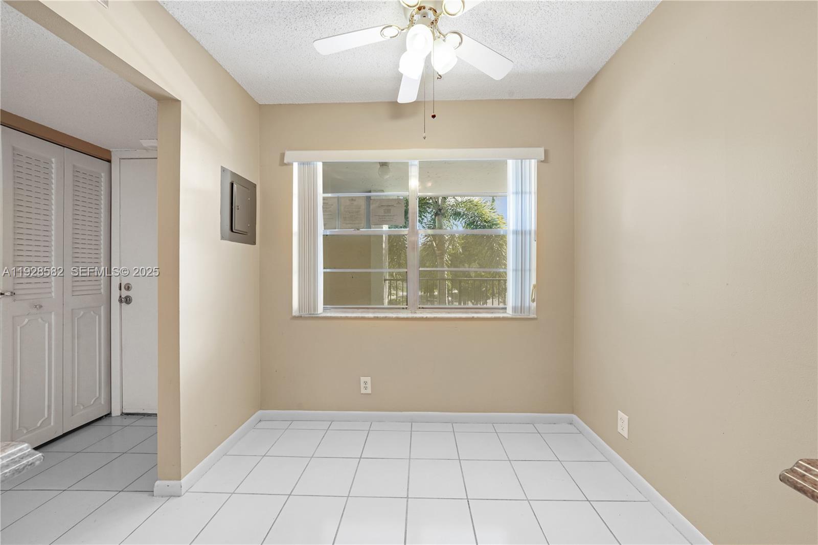 8305 Northwest 61st Street, Unit C305 Tamarac, FL 33321 - Photo 9 of 24 an empty room with windows and entrance