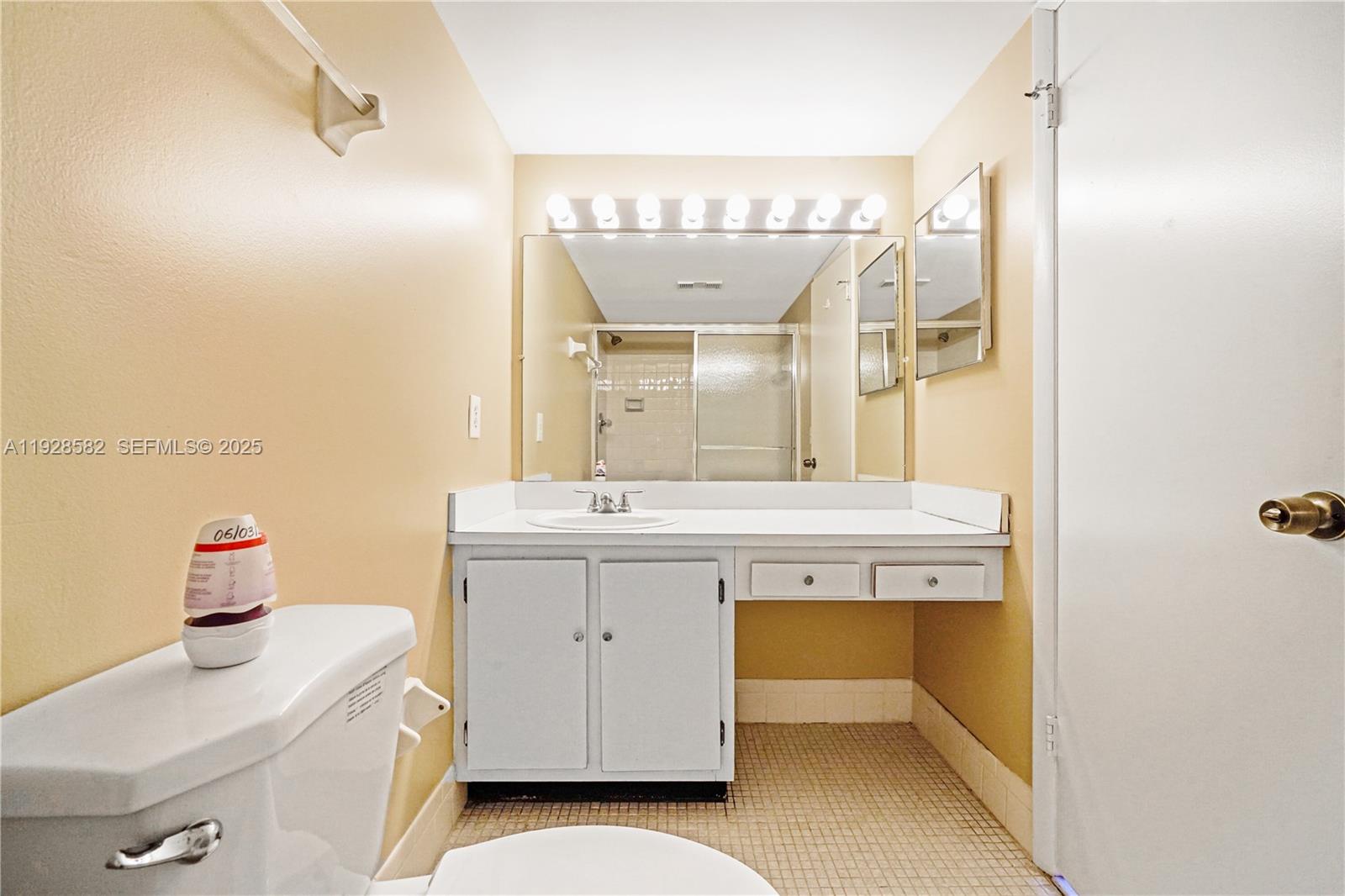 8305 Northwest 61st Street, Unit C305 Tamarac, FL 33321 - Photo 10 of 24 a bathroom with a sink and a mirror